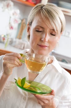 Young woman drinking green tea close up