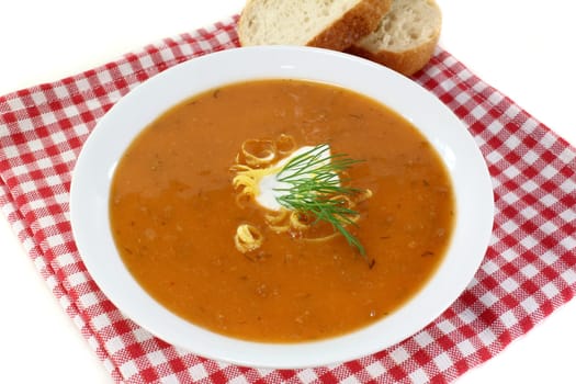 a bowl of lobster cream soup with dill and lemon