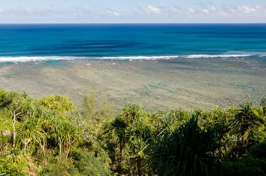 Sealodge beach in Kauai with waves breaking on reef out at sea