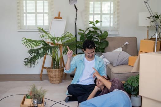 A gay couple works together to decorate their new home, showcasing their creativity and love during the moving process.
