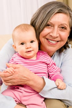 Senior woman hold little baby girl cute smiling close-up