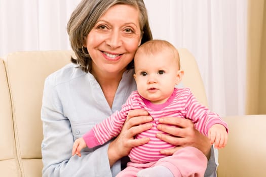 Senior woman hold little baby girl cute smiling close-up