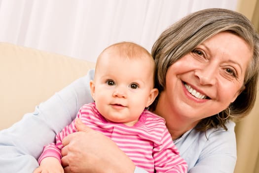 Senior woman hold little baby girl cute smiling close-up