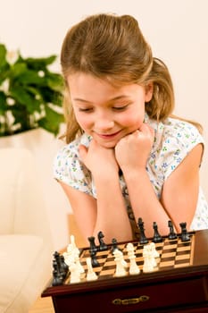 Young girl play chess cute smile alone at home