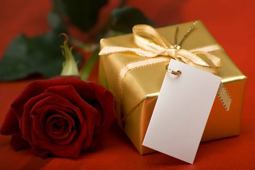 golden present with red rose close up shoot