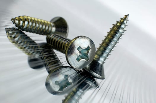 Three screws on metallic background close up shoot
