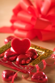 heart shaped candy on a golden plate close up