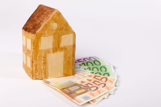 House carved from wood on banknotes as a symbol of house construction