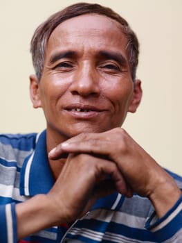 Portrait of happy mature Asian man smiling and looking at camera