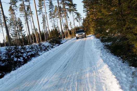 suv, 4x4, driving on snowy country-road, winter time in sweden
