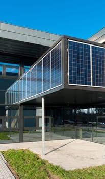 entrance of a modern office building with solar panels for energy supply
