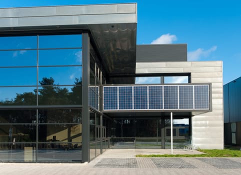 entrance of a modern office building with solar panels for energy supply