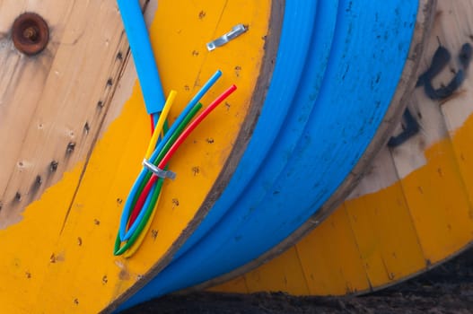 cable on cable drum containing four cables in different colors