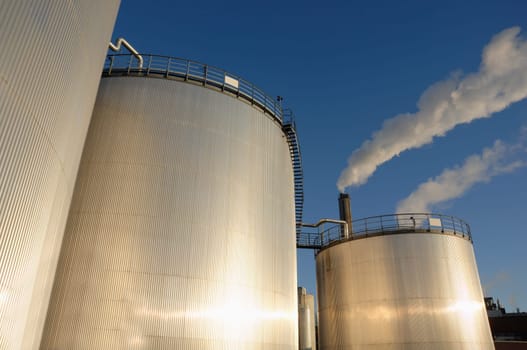 giant fuel-storage towers, drenched in sunlight