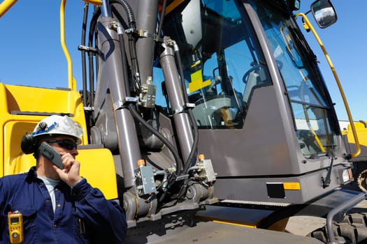 driver, worker, standing outside bulldozers controle room