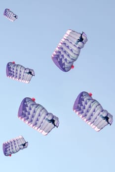 Many parachutes over a blue sky background