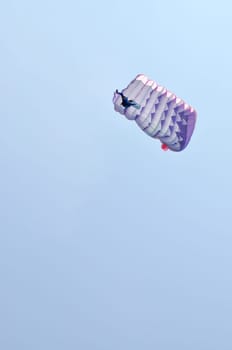 A parachute over a blue sky background