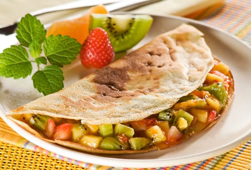 Pancake filled with mixed fruit close up shoot