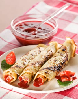 Pancakes with strawberry jam close up shoot