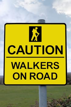 warning sign for drivers to be careful of tourists walking on country roads with clipping path