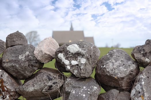 old stone wall with church in background in ballyvaughan county clare ireland