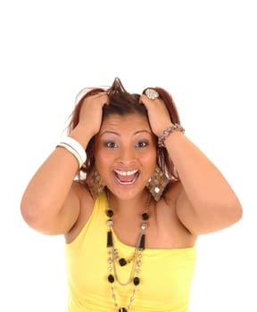 A young pretty Hispanic woman is very angry and messing her hair for white background in a yellow dress and a nice necklace.