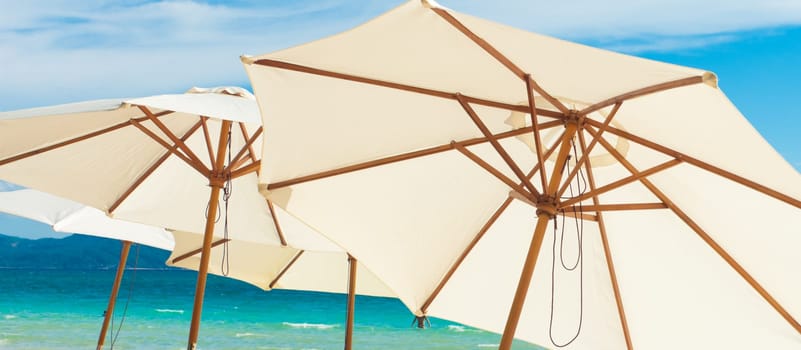 white umbrellas on a tropica beach