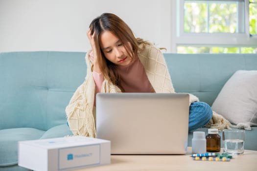 Sick female covered blanket searching instructions medical online with drugs, Sick young woman sit on sofa videocall online with laptop consult with doctor at home, Medicine healthcare and technology