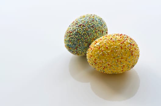 Two Easter eggs with sprinkles
