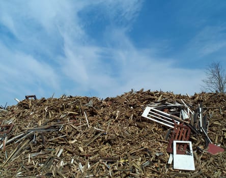Heap of Wood Garbage in front of blue sky