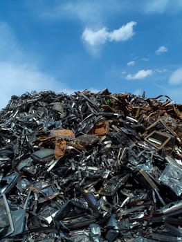 Stack of Metal Garbage in front of blue sky