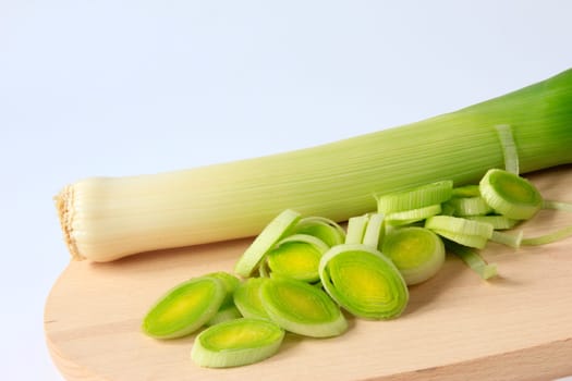 Leeks,whole and sliced on a wooden board
