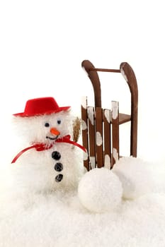 a snowman with sleigh in the snow