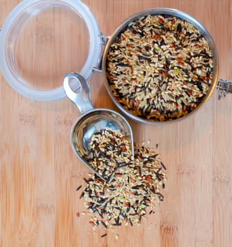 Top view of an open jar with wild rice on a cutting board