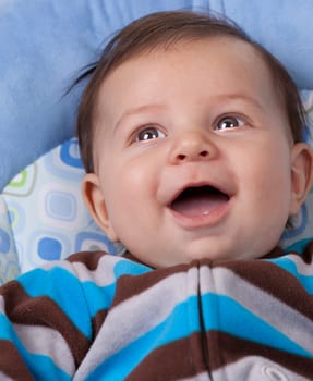 Portrait of a baby boy laughing and smiling