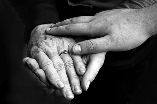Hands of young and old - hands that help each other