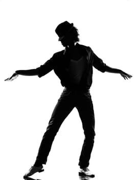 full length silhouette of a young man dancer dancing funky hip hop r&amp b on  isolated  studio white background