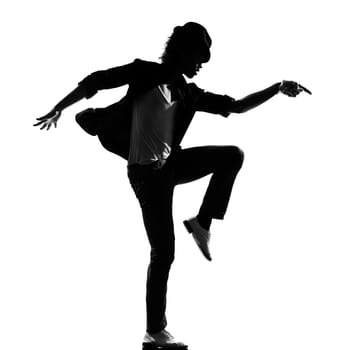 full length silhouette of a young man dancer dancing funky hip hop r&amp b on  isolated  studio white background