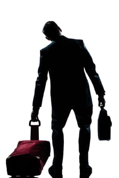 rear view one caucasian business traveler man tired with suitcase  full length silhouette in studio isolated white background