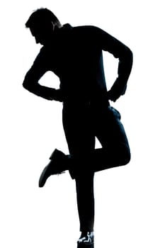 one caucasian man  looking at his shoes full length silhouette in studio isolated white background