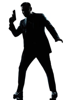 one caucasian spy criminal policeman detective man holding gun full length silhouette in studio isolated white background
