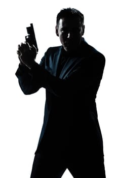 one caucasian spy criminal policeman detective man holding gun portrait silhouette in studio isolated white background