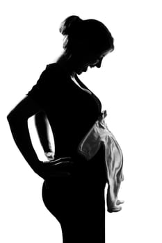 beautiful caucasian pregnant woman baby clothes in silhouette on studio isolated white background