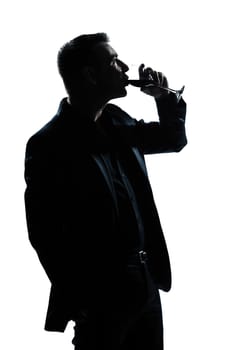 one caucasian man portrait silhouette drinking red wine in studio isolated white background