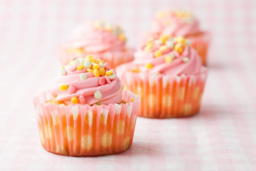 Close-up of delicious pink muffins. Studio shot.