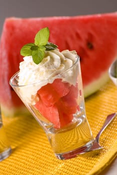 watermelon in glass with cream close up