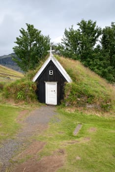 small wooden church with a grass roof in Iceland
