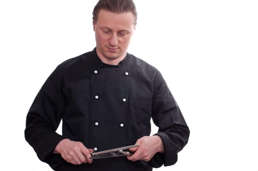 A man as a cook does sharpen a knife on a sharpening steel