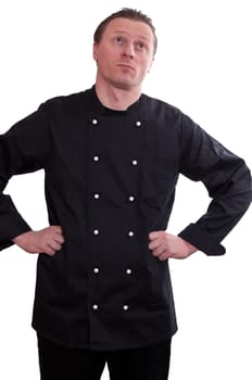 A man as a cook looks up and frowns