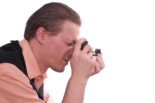 A male photographer takes pictures and holds a camera in his hands